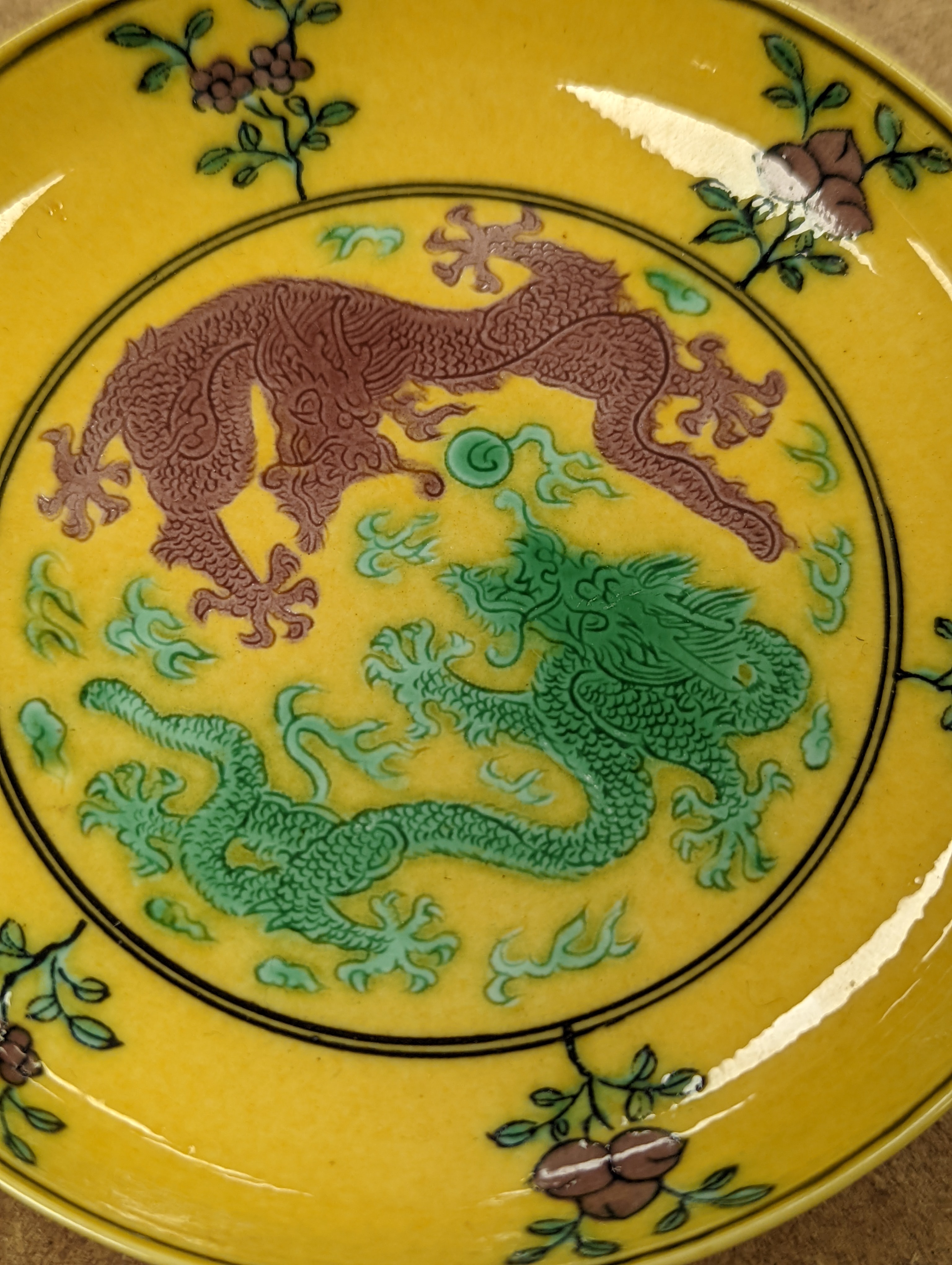 A Chinese yellow ground green and aubergine enamelled 'dragon' dish, Guangxu mark and possibly of the period, D.11cm
